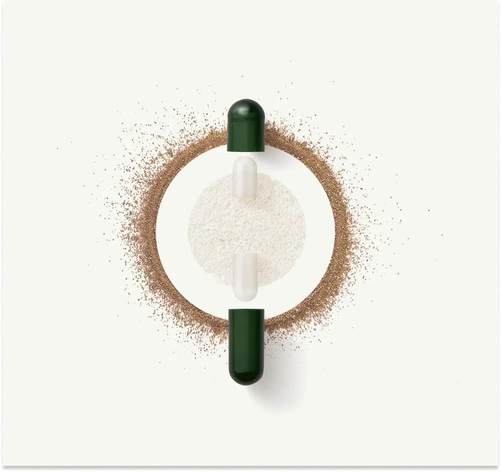 A green capsule pulled apart with its contents spread in a ring around it