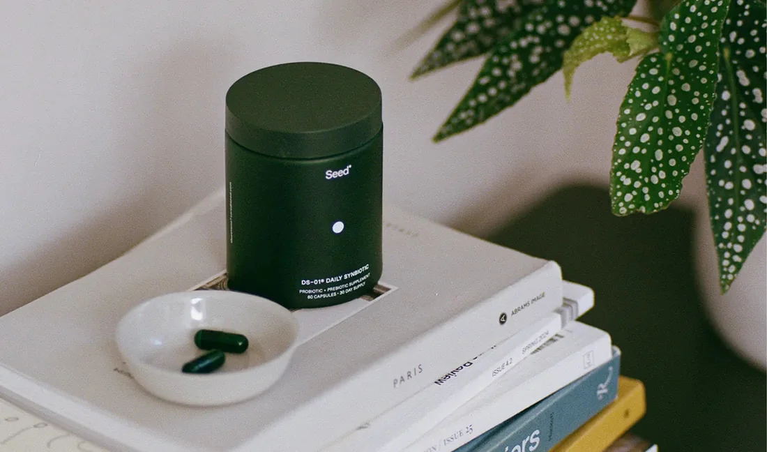 The DS-01 jar standing on a stack of books next to a plant