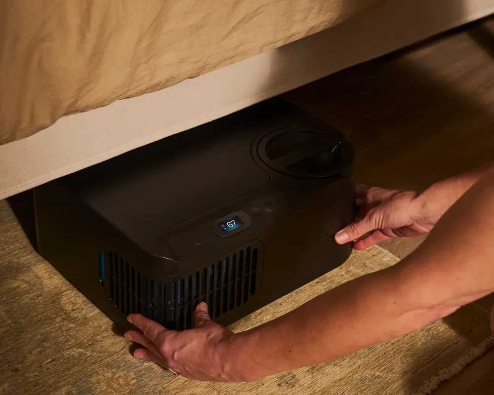 The Chilipad dock unit sitting on the floor under the bed frame