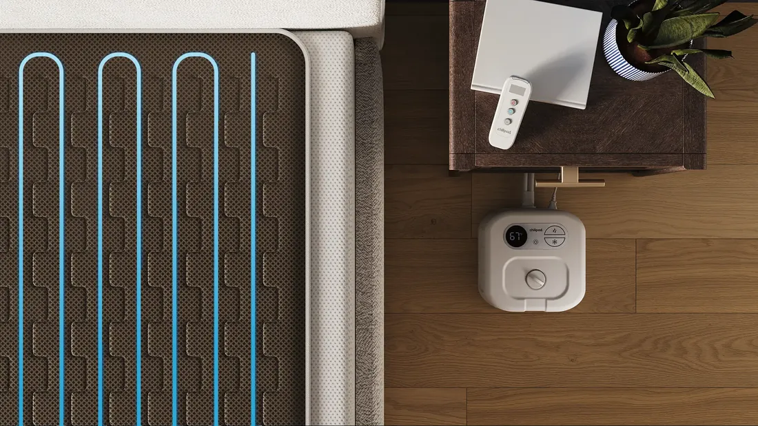 Close-up of the water channels running across a Chilipad sleeping surface, with the dock unit beside the bed
