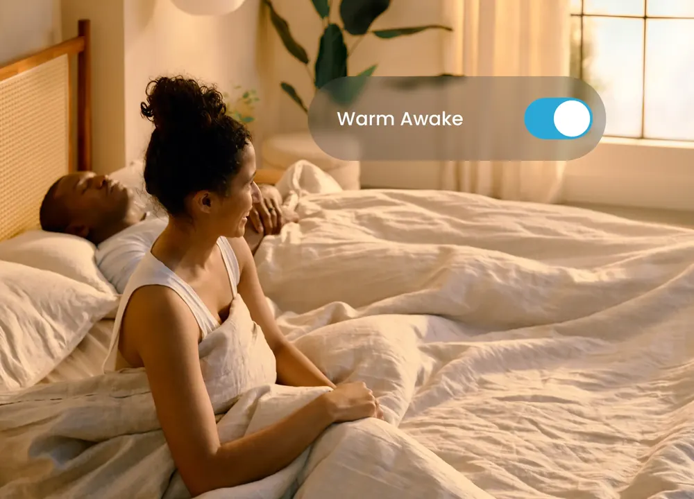 A bedroom in morning light illustrating the Warm Awake feature
