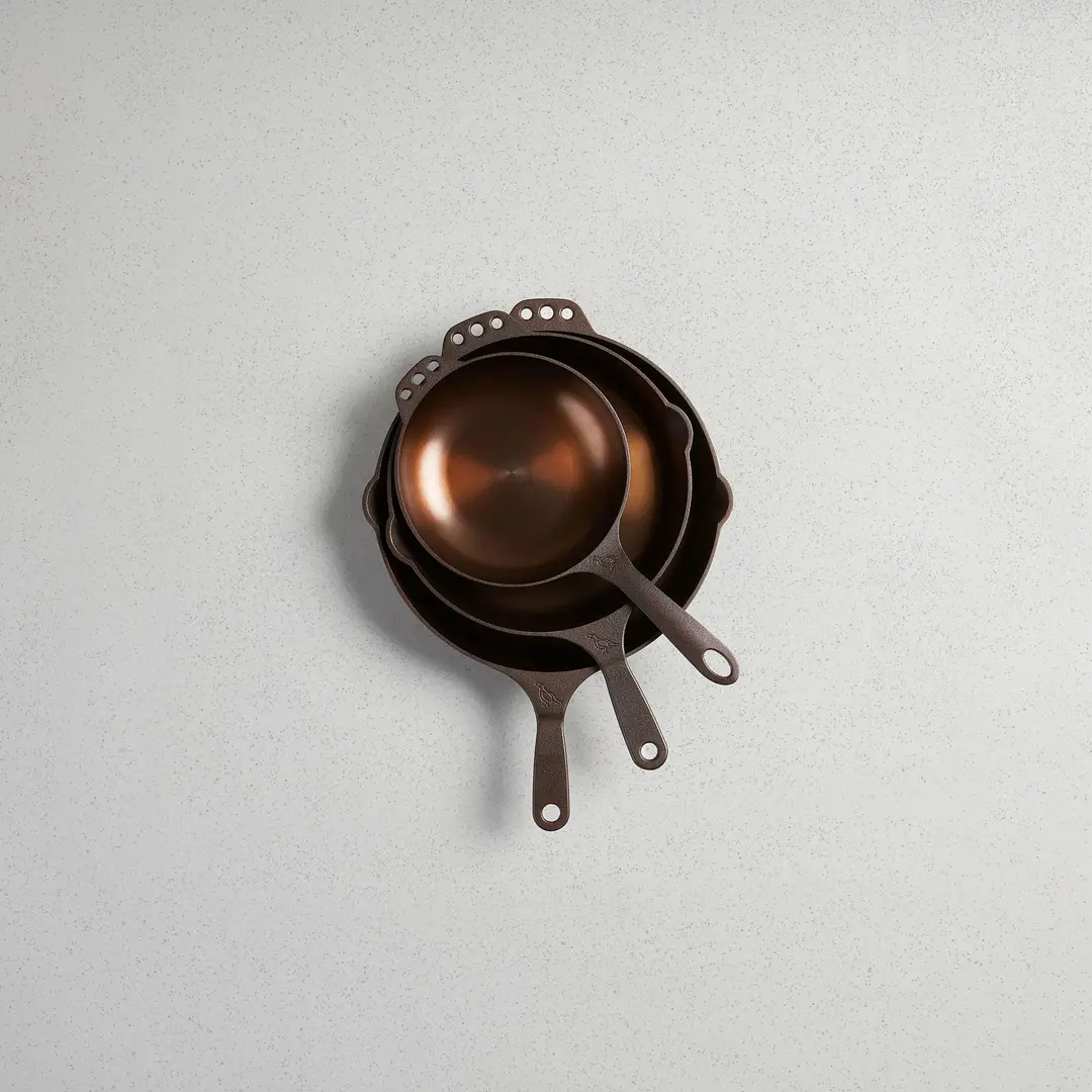 Two Smithey cast iron skillets nested inside each other, seen from above.