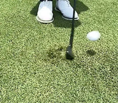 The QX-1 wedge gliding through the same lie with the ball already launched off the face