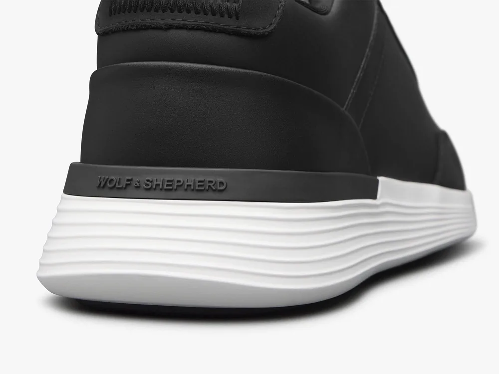 Close view of the layered white performance midsole and branded heel counter
