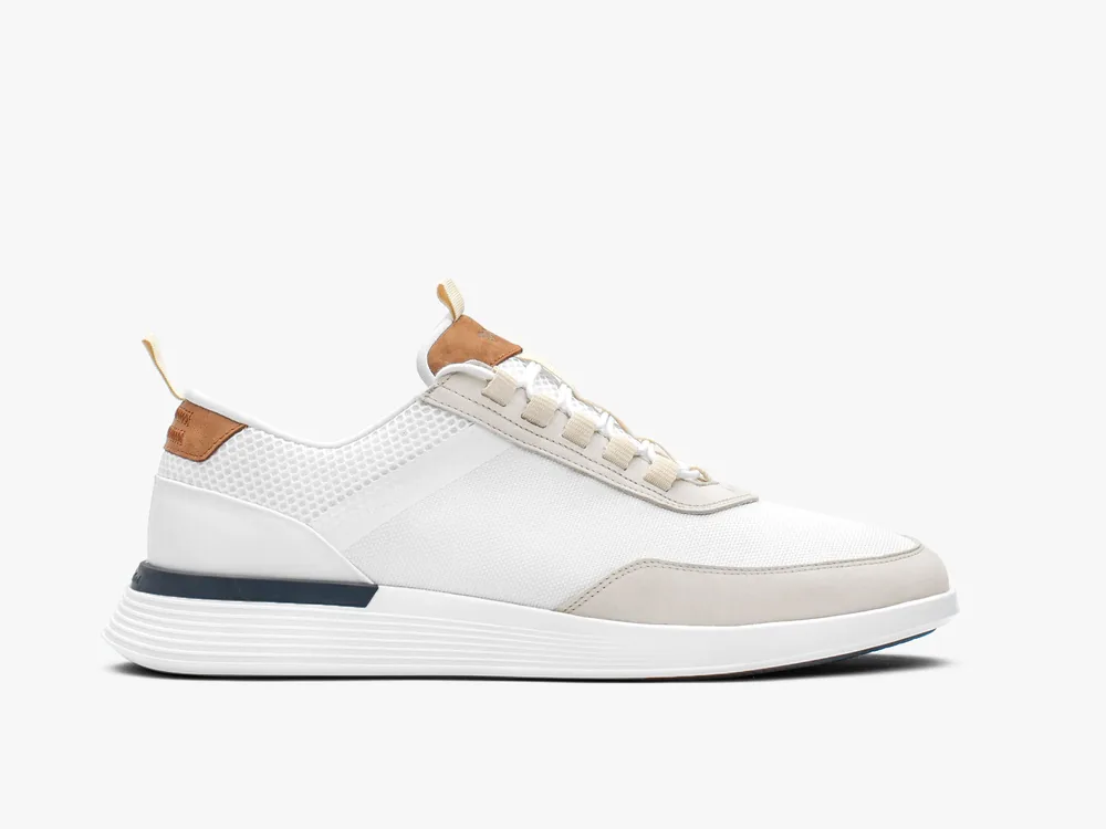 Lateral view of the white Crossover Victory Trainer showing the leather upper, tan heel tab and layered midsole