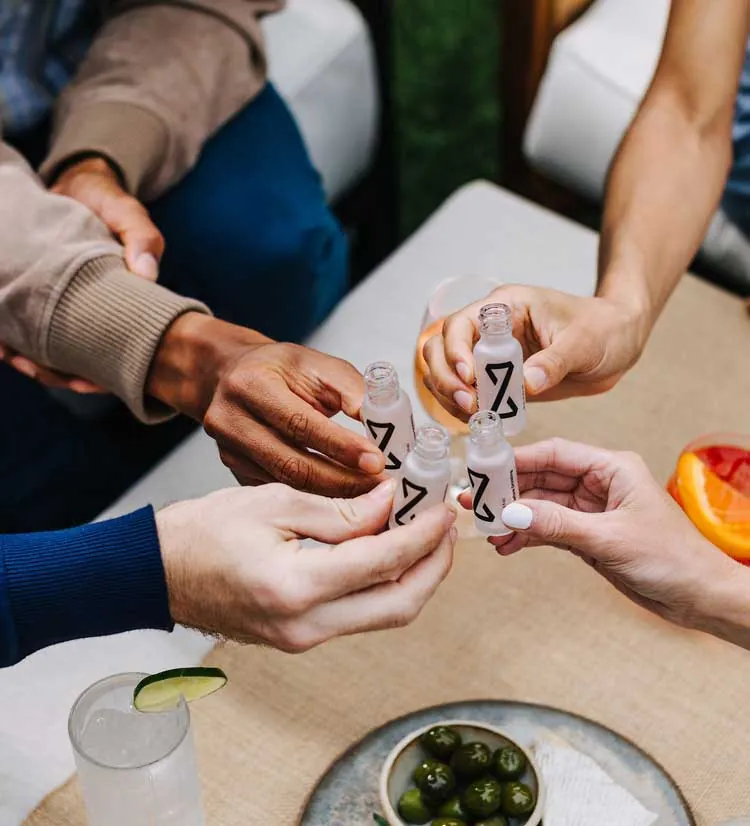 Group of friends raising drinks together at a table